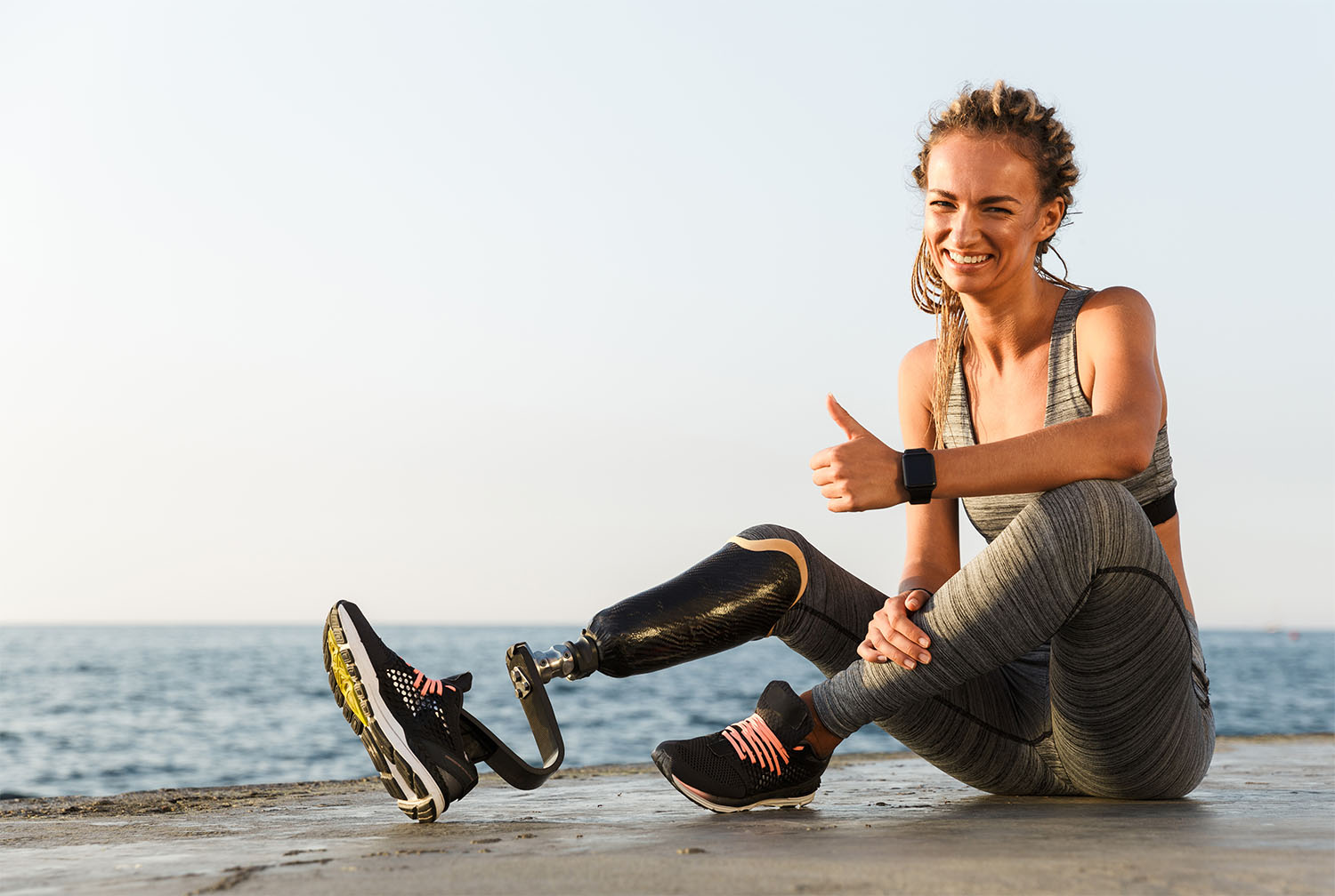 Smiling athlete woman with prosthetic leg